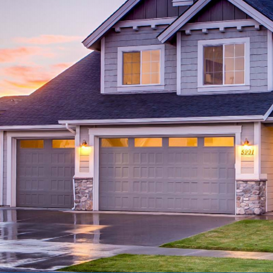 Modern home with garage door at dusk
