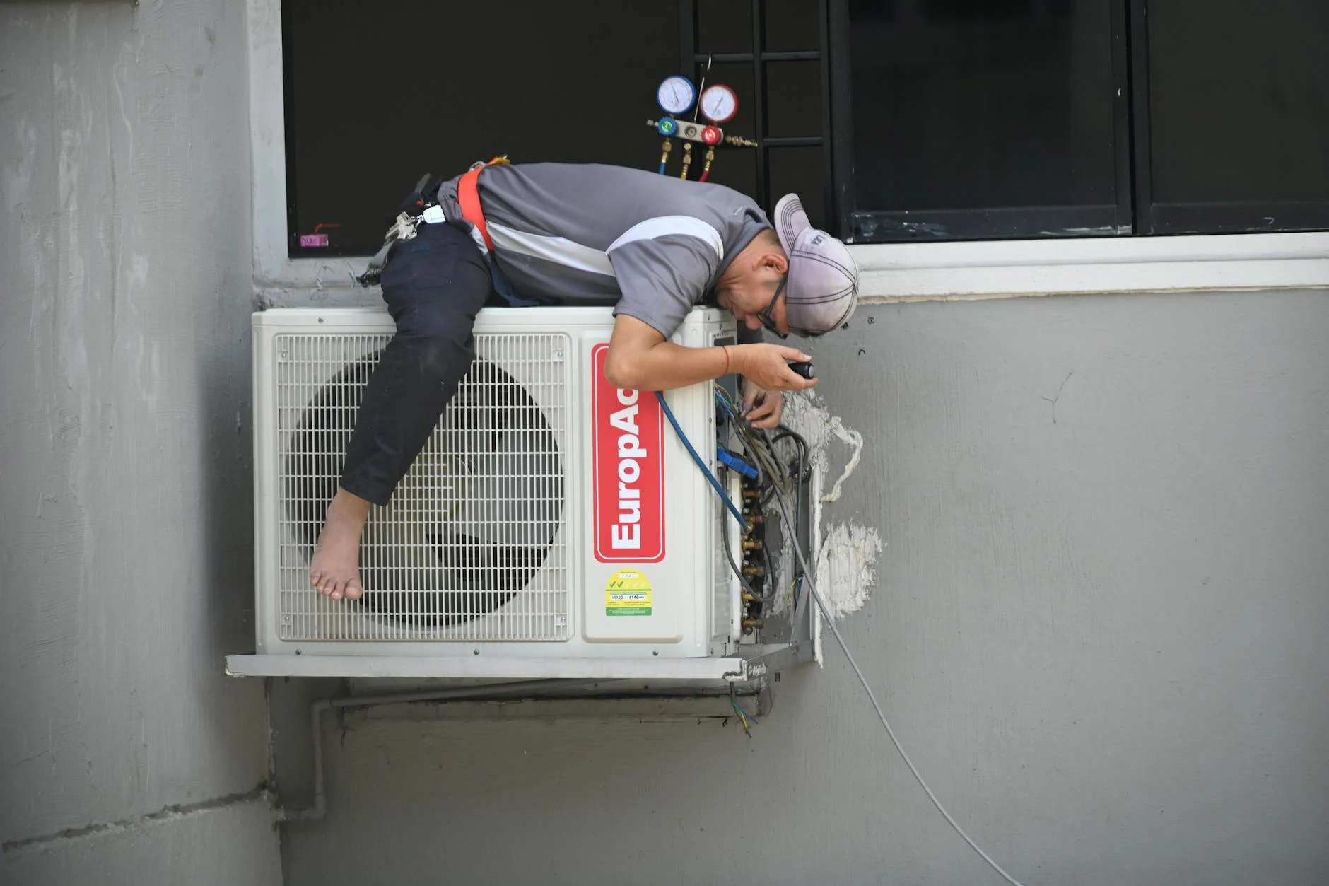 HVAC technician repairing outdoor AC unit