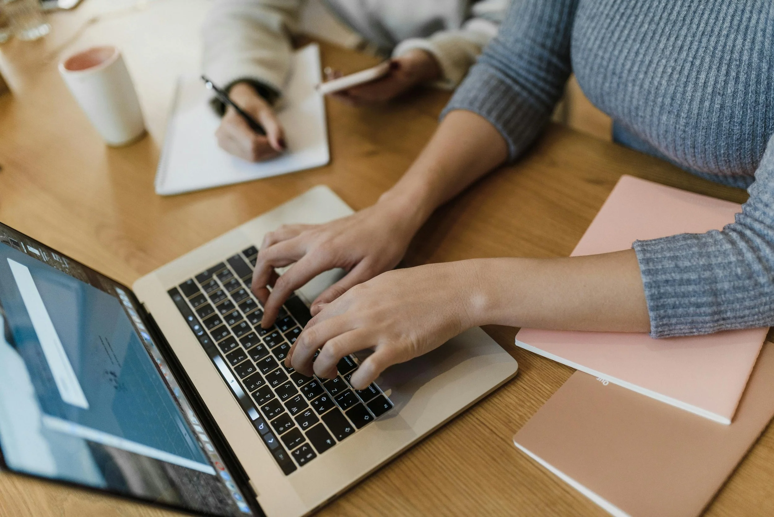 Person working on tax documents at laptop