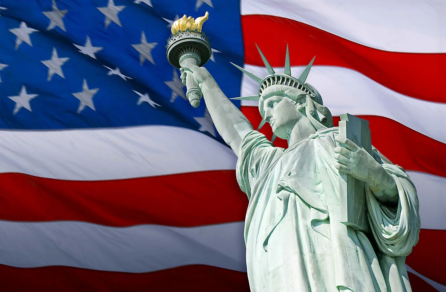 Composite image of American flag with Statue of Liberty in front.
