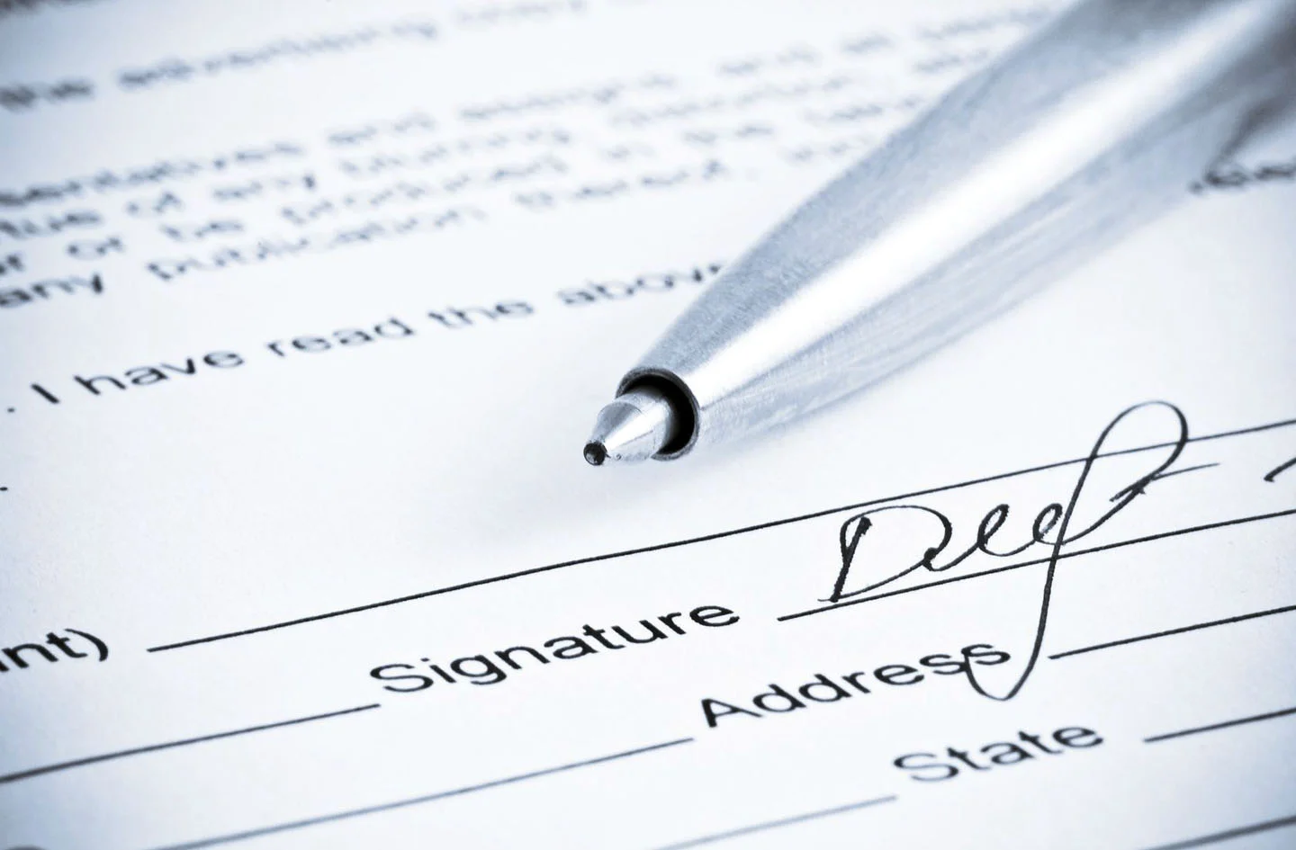Illustrative image of a form, with a pen and signature.