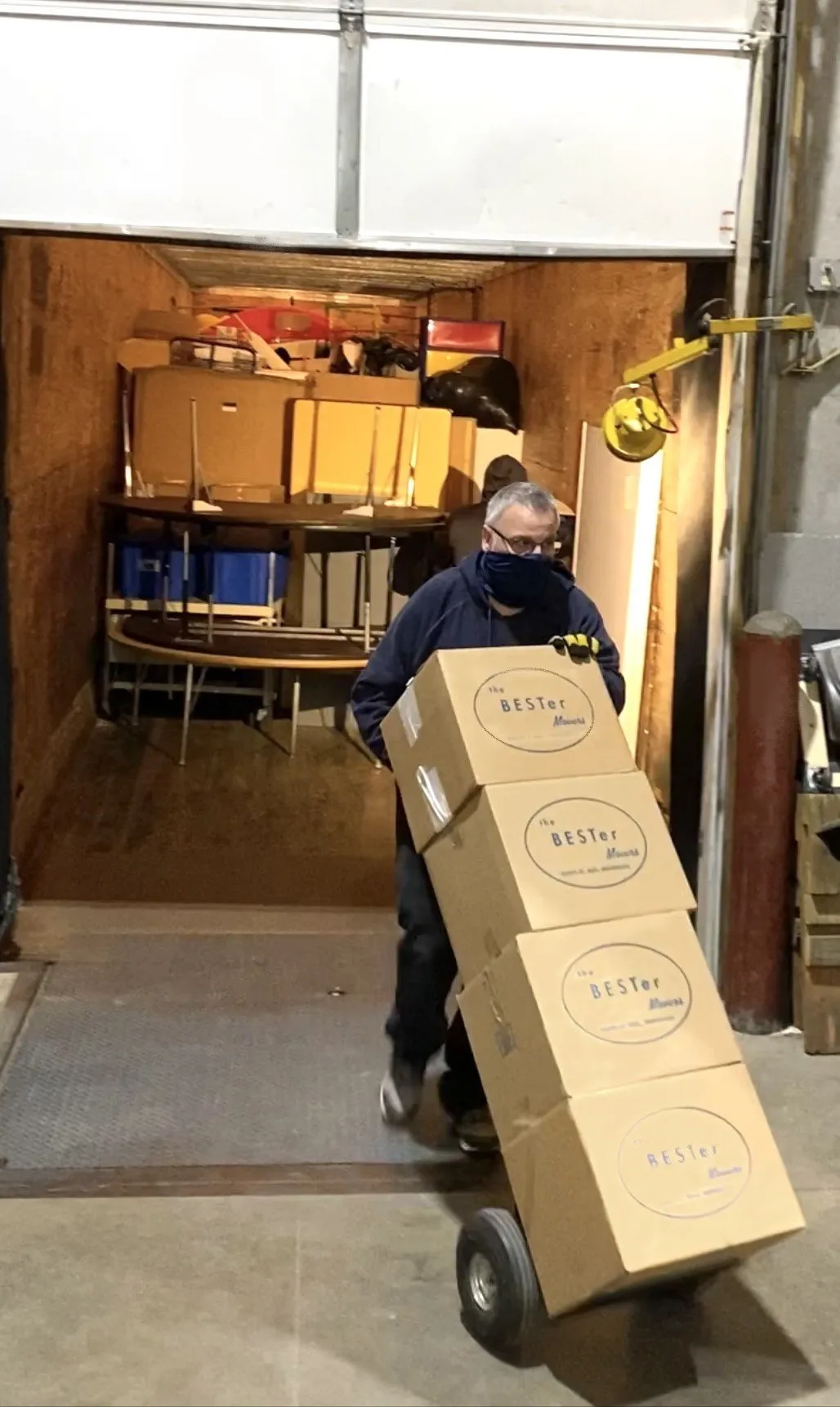 A Man Moving Boxes — Bester Bros