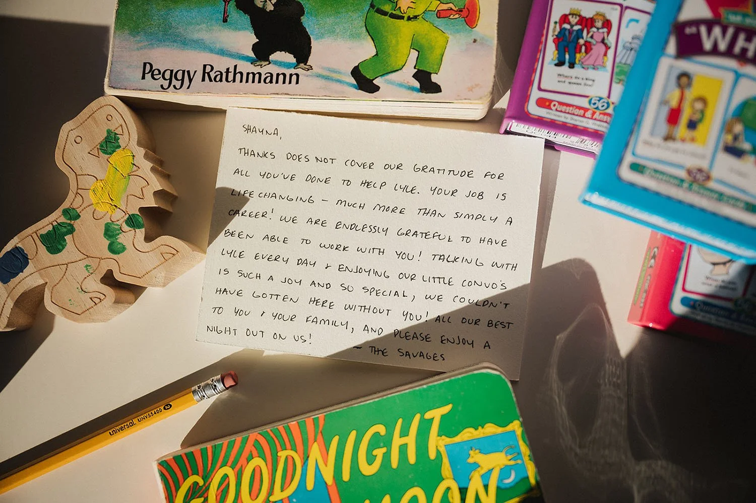 Handwritten testimonial surrounded by books and toys