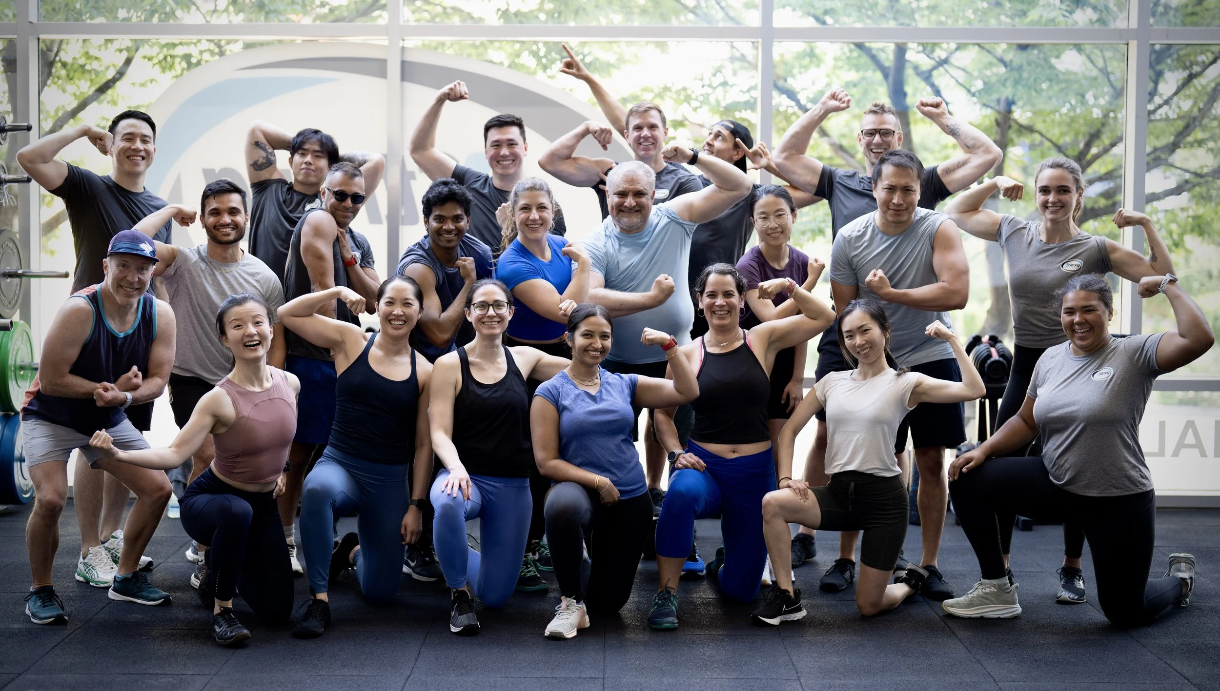 Group shot of bStrong members smiling and flexing