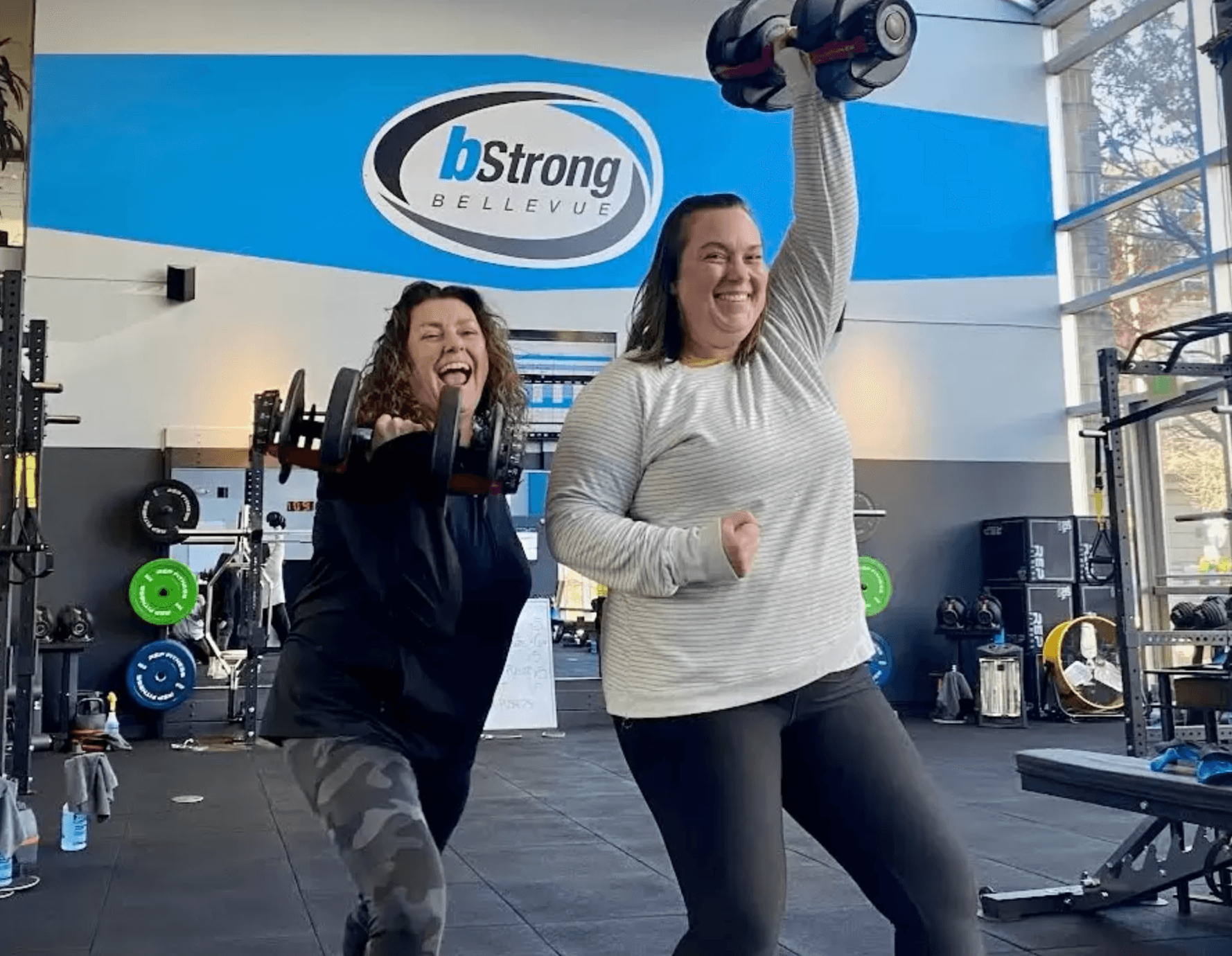 bStrong members having fun with dumbbells in the gym