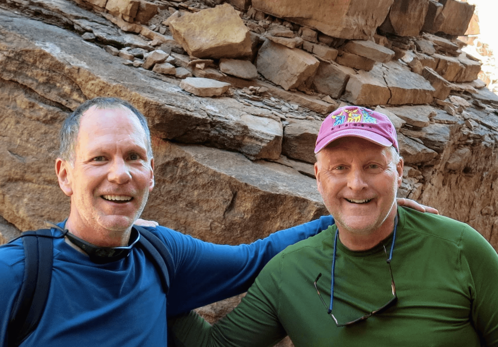 bStrong members with arms around each other during an outdoor adventure
