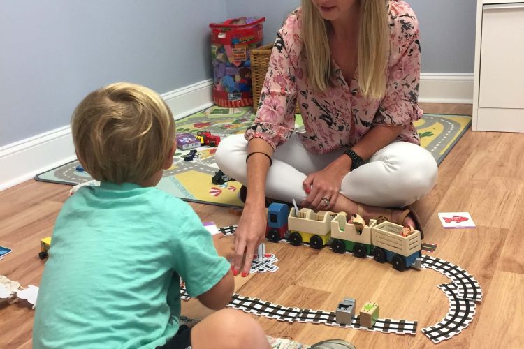 Kelsey with child during therapy
