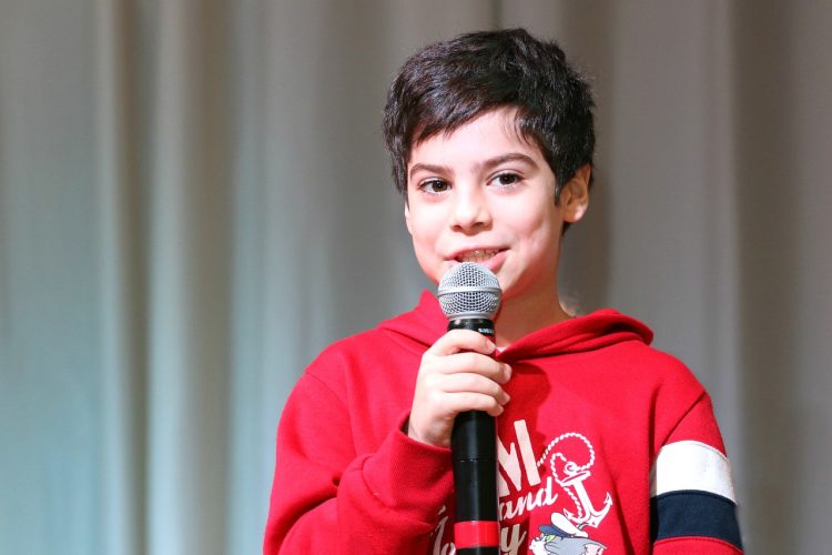 Child using microphone during speech therapy