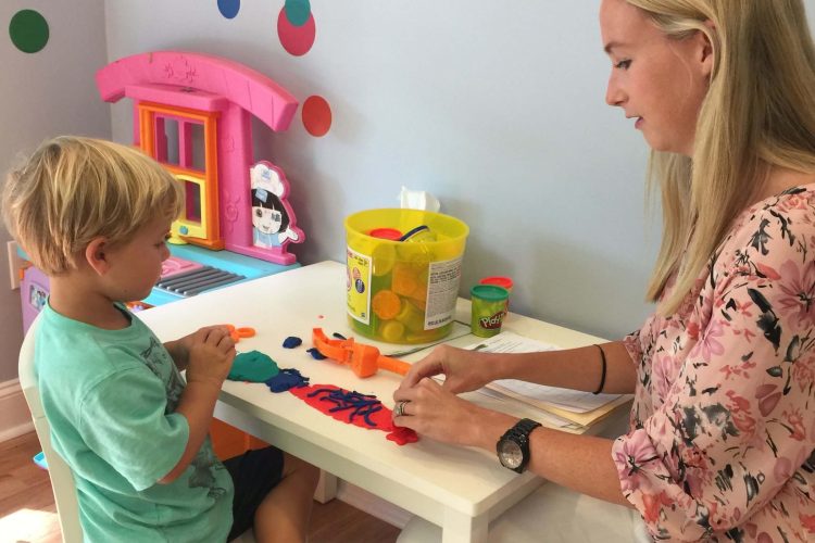 Therapist working with child at table