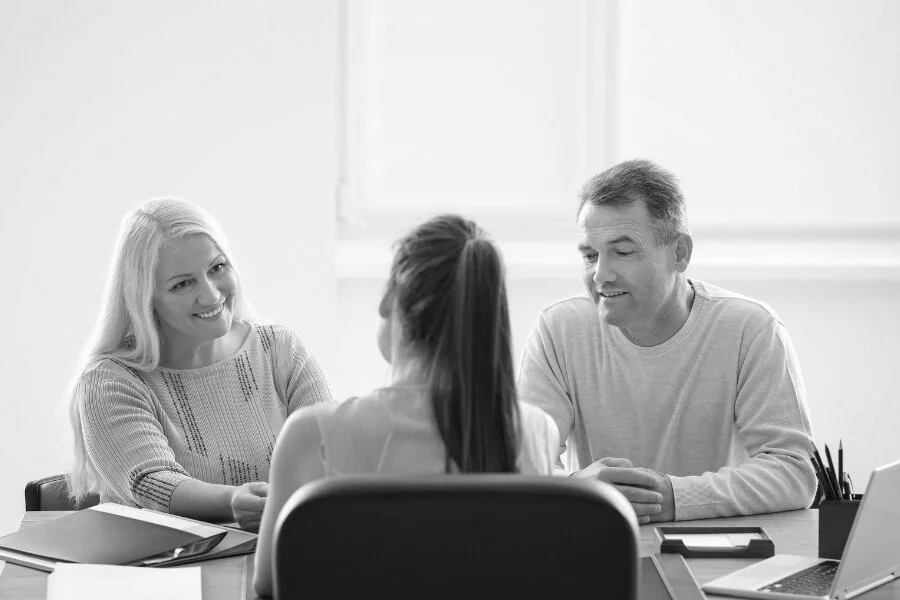 Couple sitting with a Loan Signing Agent