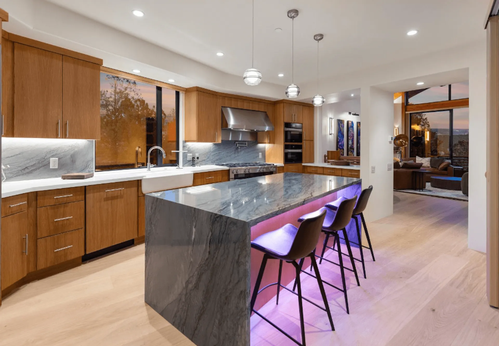 A modern kitchen with purple accent lights