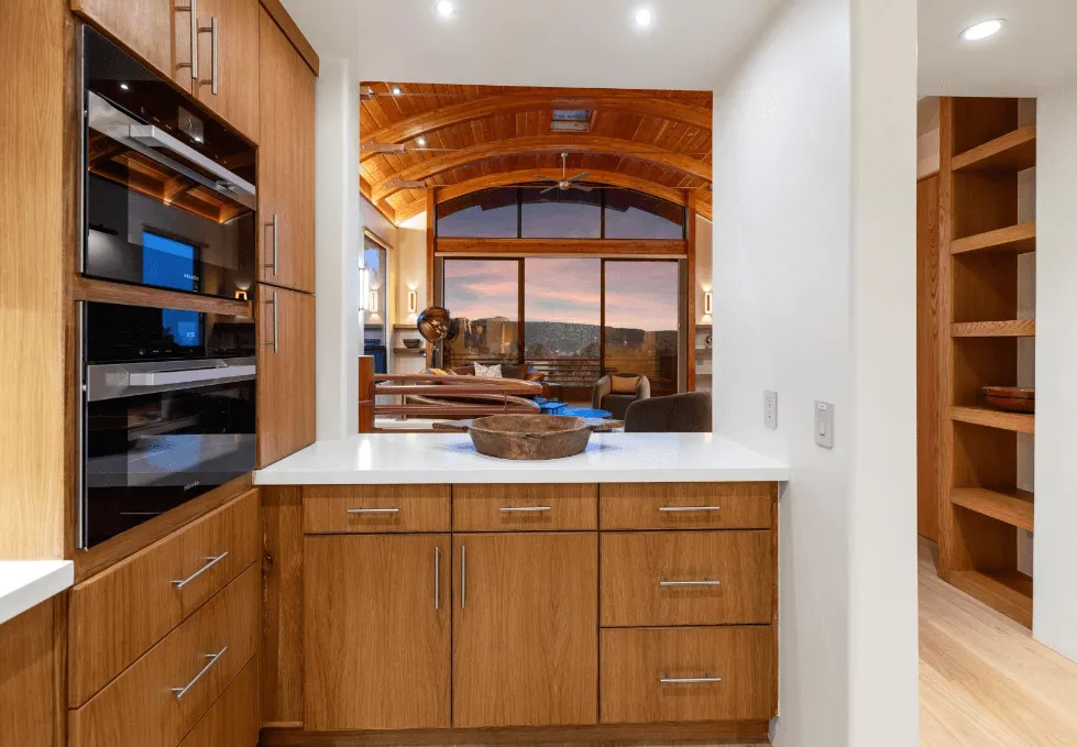 Kitchen with wooden cabinets and a large window
