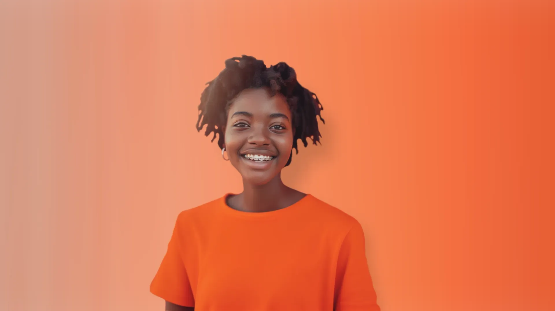 A young woman in an orange shirt smiling
