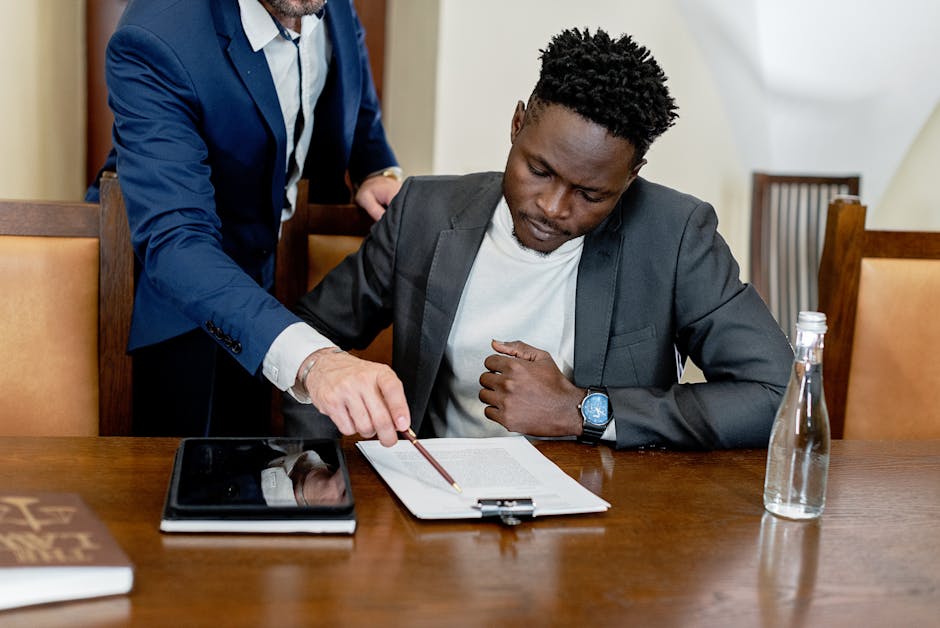 Mobile notary guiding a client through signing documents at a desk