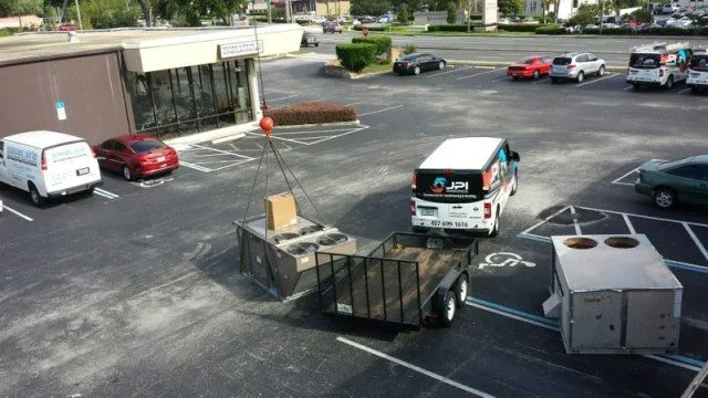 Crane lifting commercial HVAC unit