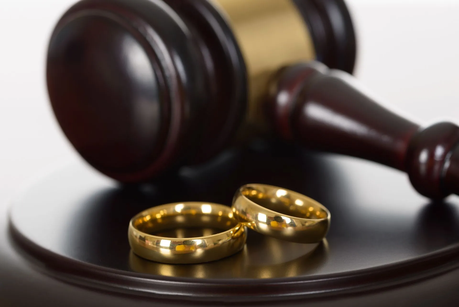 Family law gavel and wedding rings