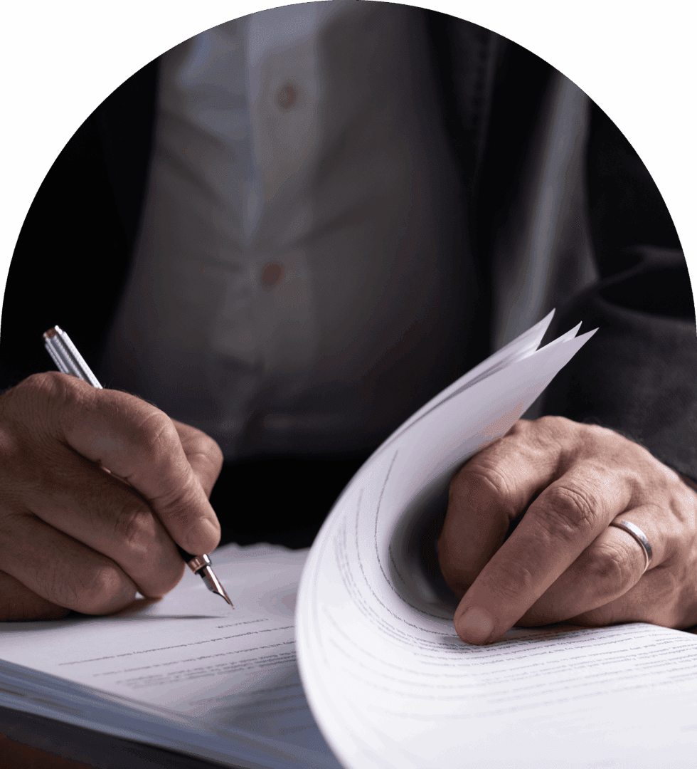 Person signing a stack of documents.