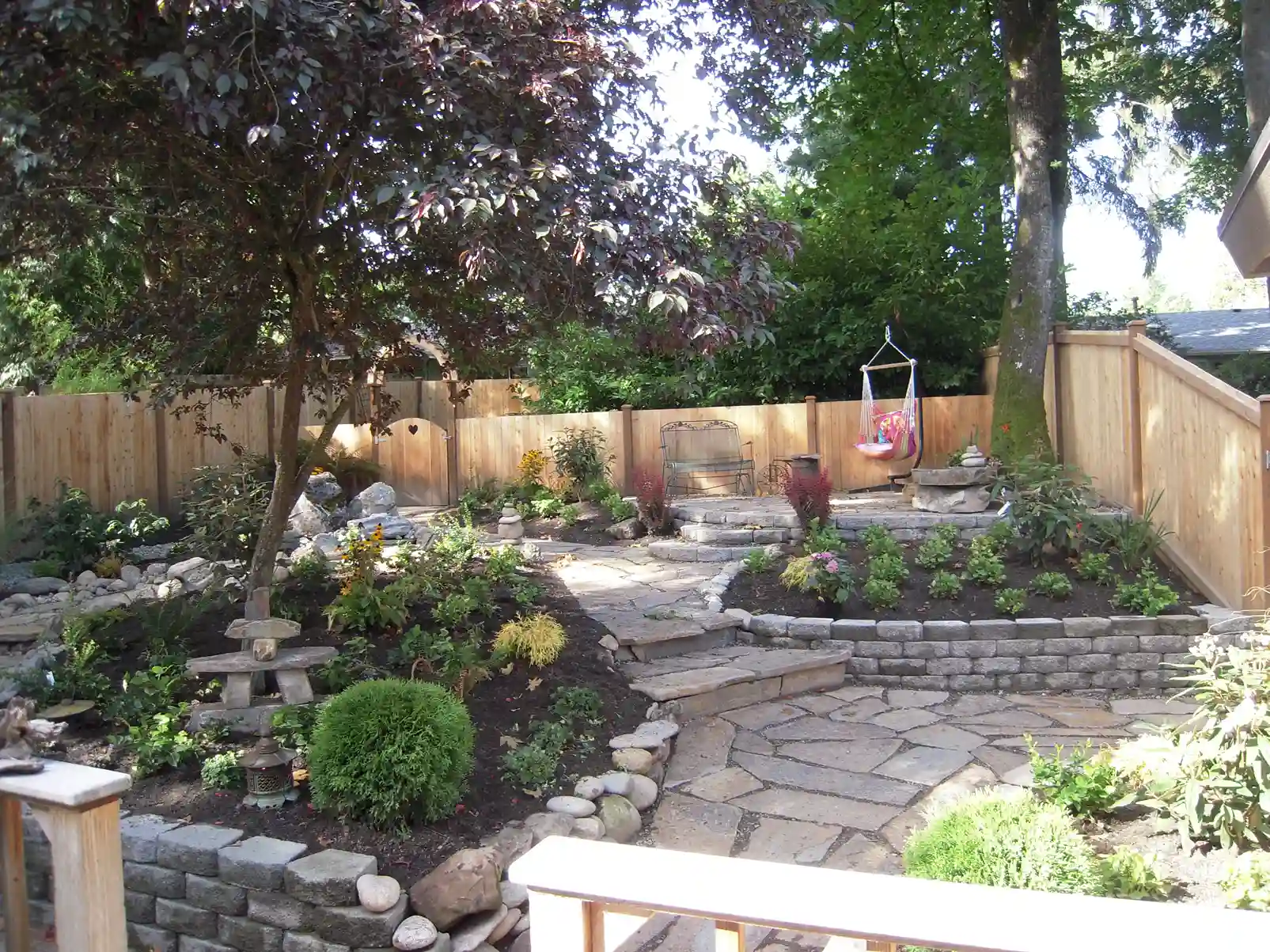 Landscaped backyard with stone path and hardscape