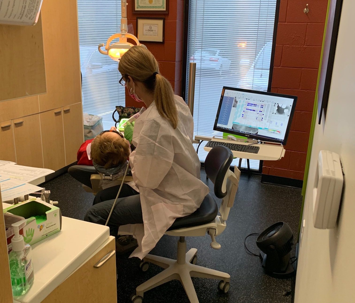 Dentist examining patient in clinic