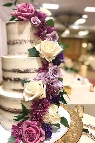 Three-tiered cake with flowers at New River Cafe & Bakery