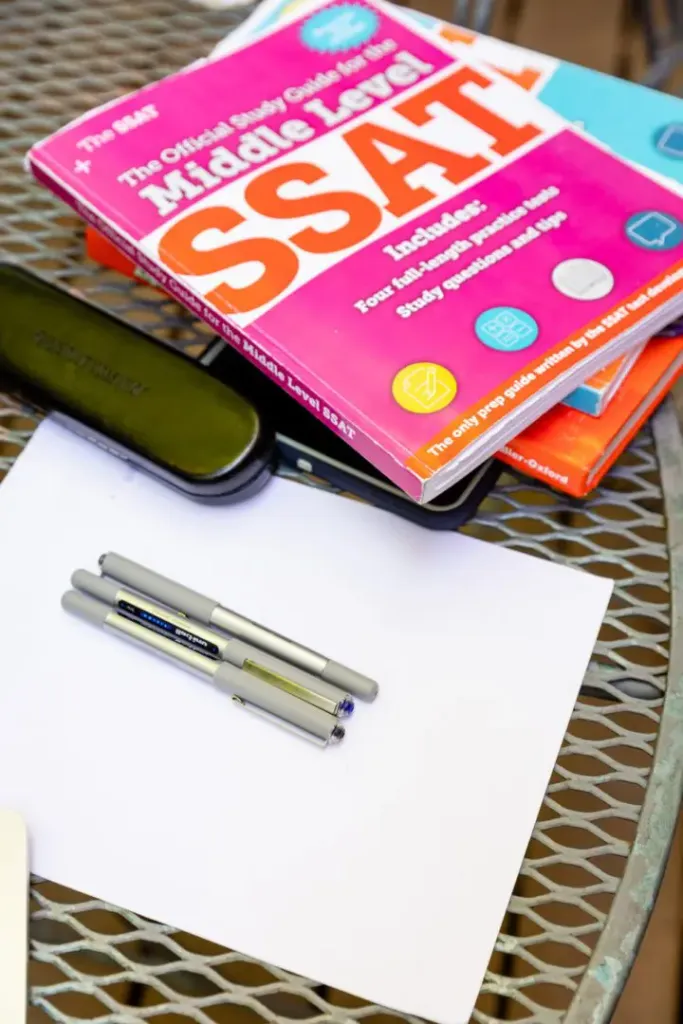 A book and some pens on top of a table.