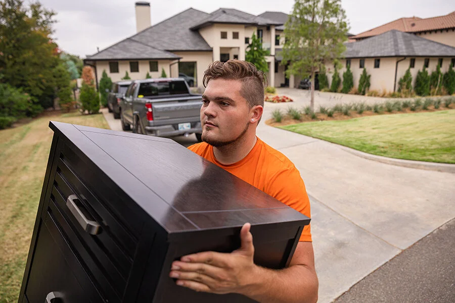 On Call Moving employee moving furniture into moving truck