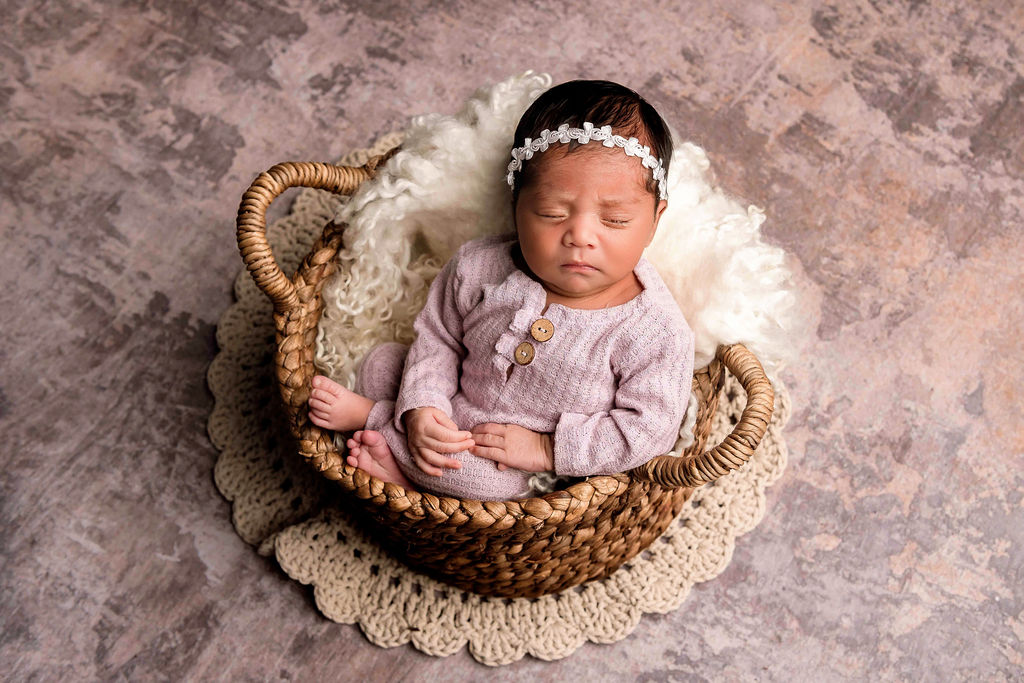 Newborn baby girl in basket
