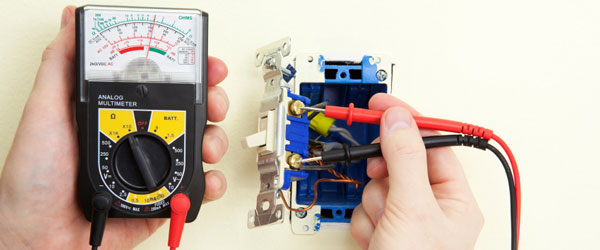 Electrician testing light switch