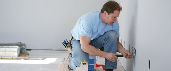 Electrician installing electrical outlet