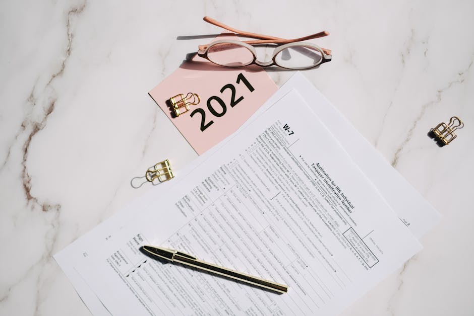 W-7 tax forms with glasses
