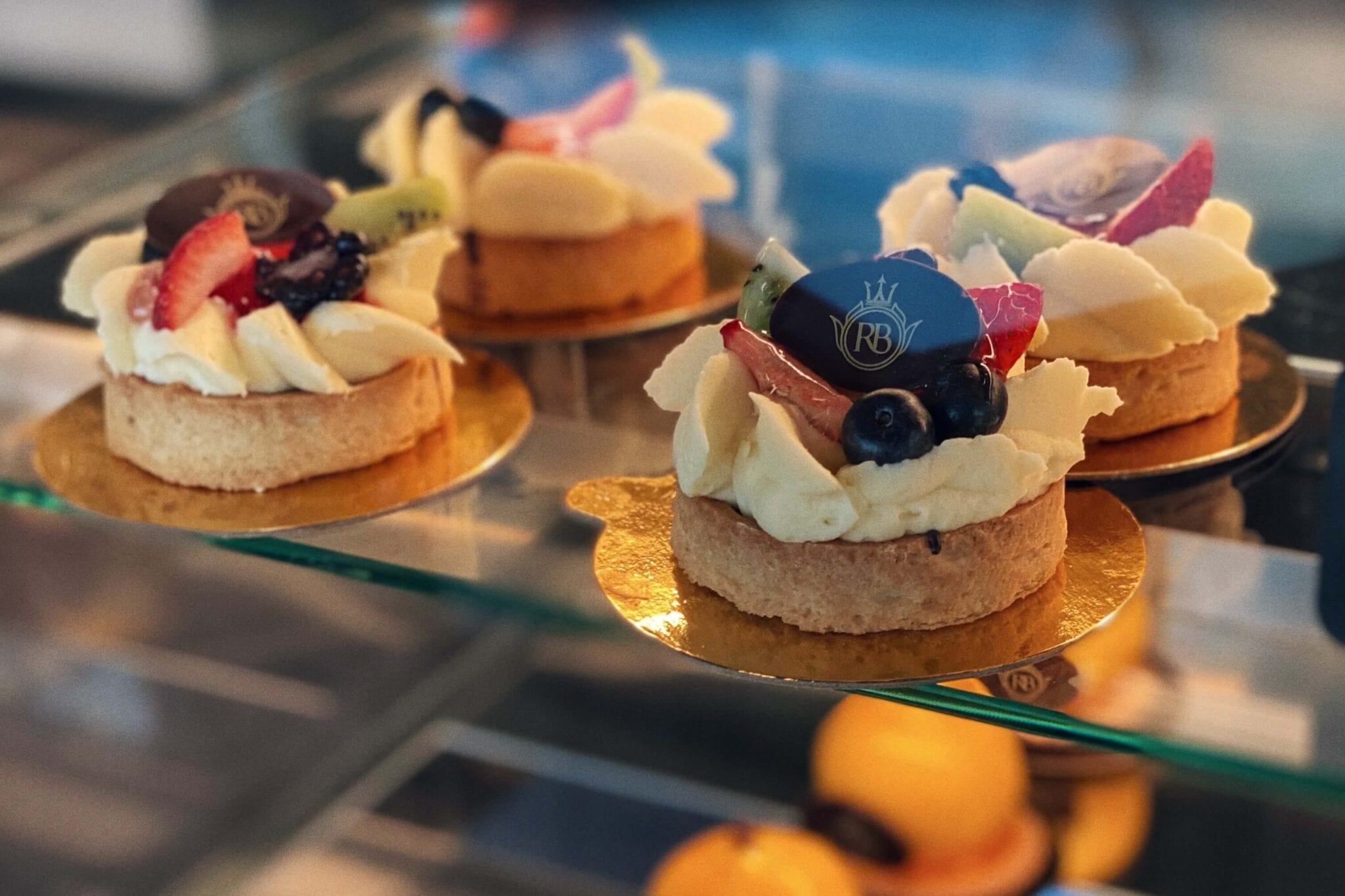 A glass display case with several pastries