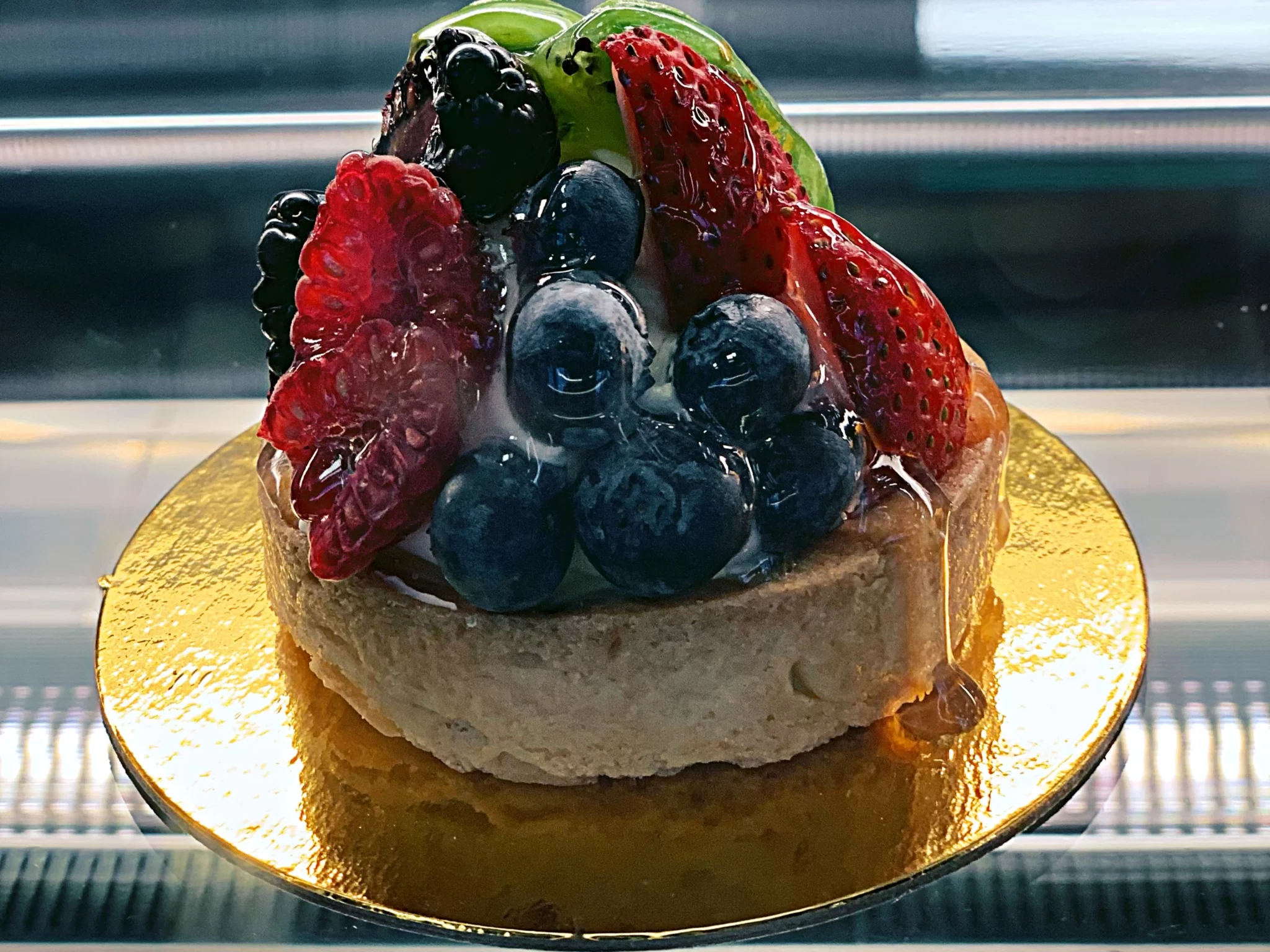 A small cake with fruit on top of it