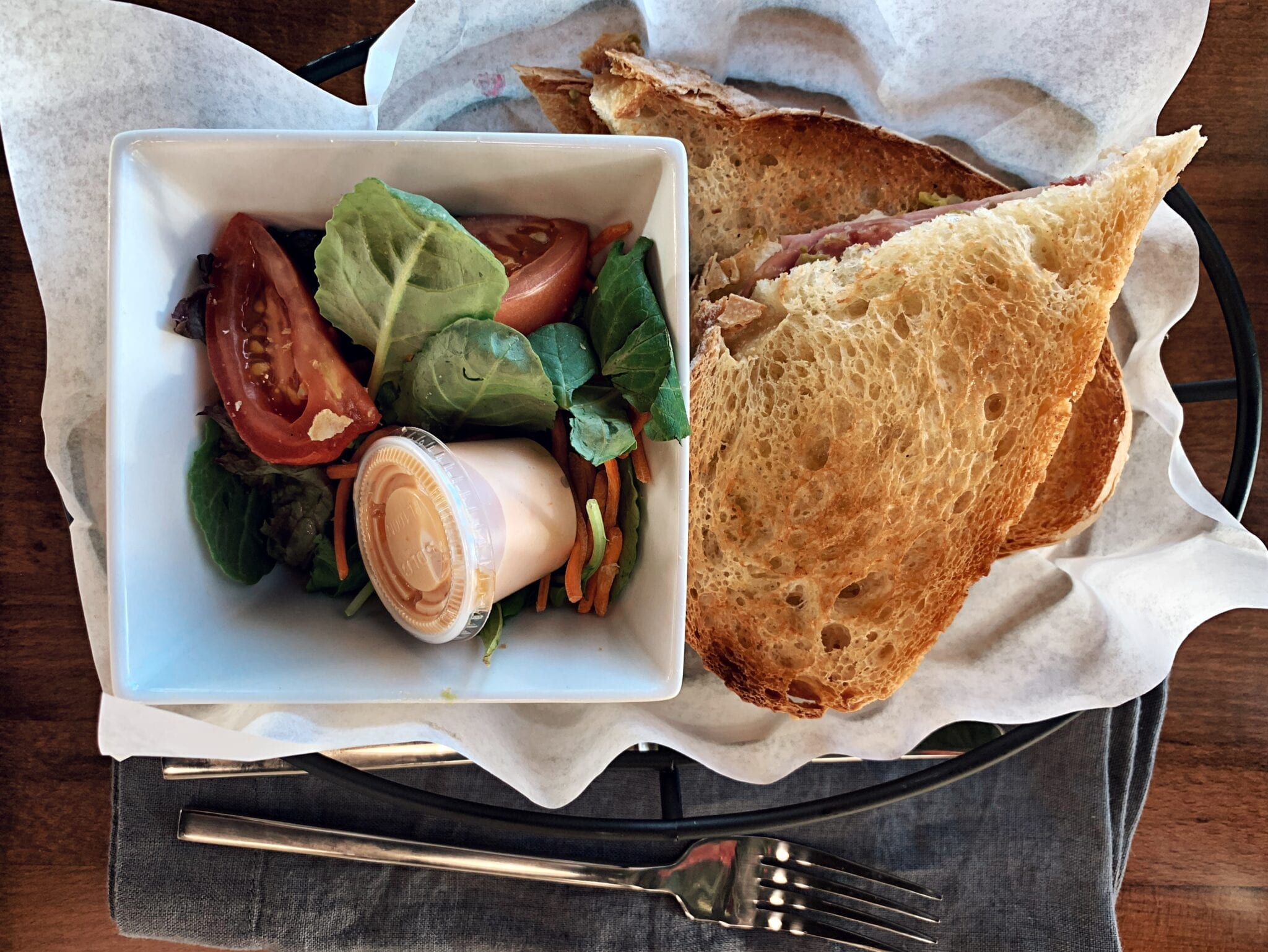 A sandwich and some salad in a bowl