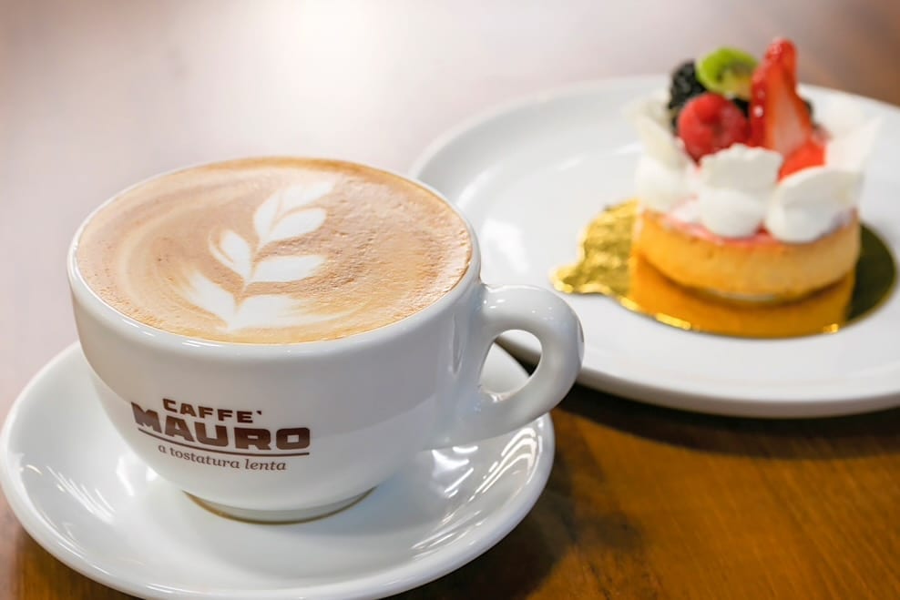 A cup of coffee and food on plates in the cafe