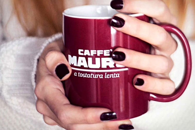 A person holding a coffee mug