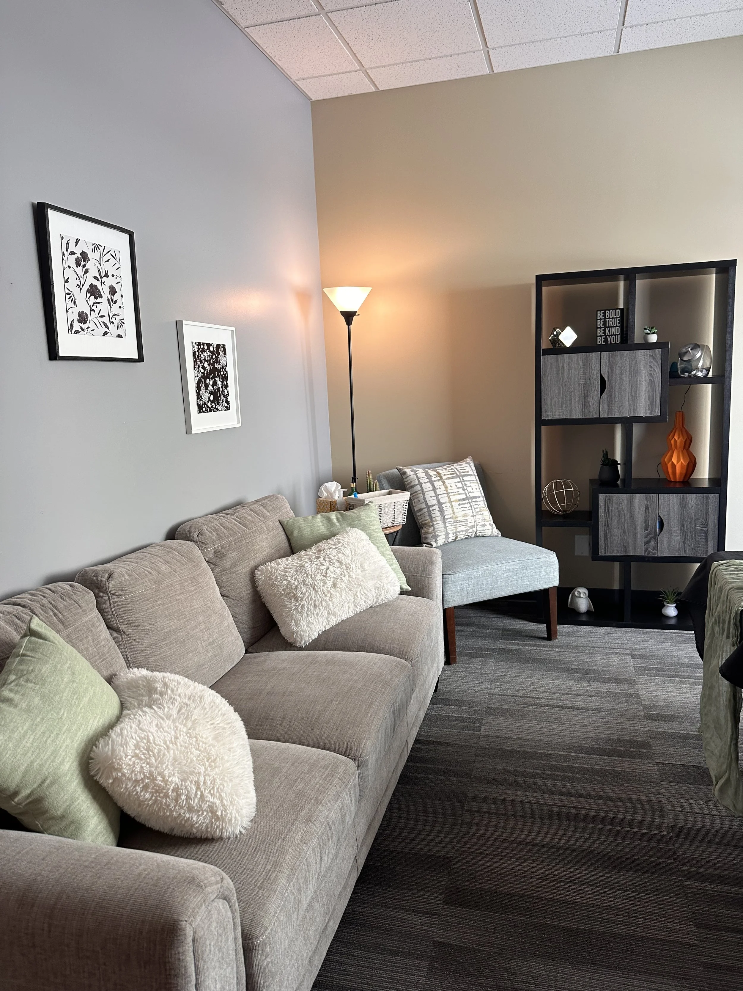 Cozy counseling room with beige sofa and warm lighting
