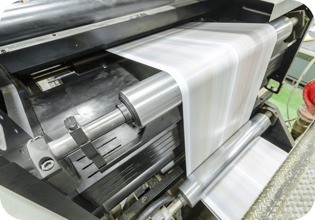 Close up of paper being rolled in a printing press