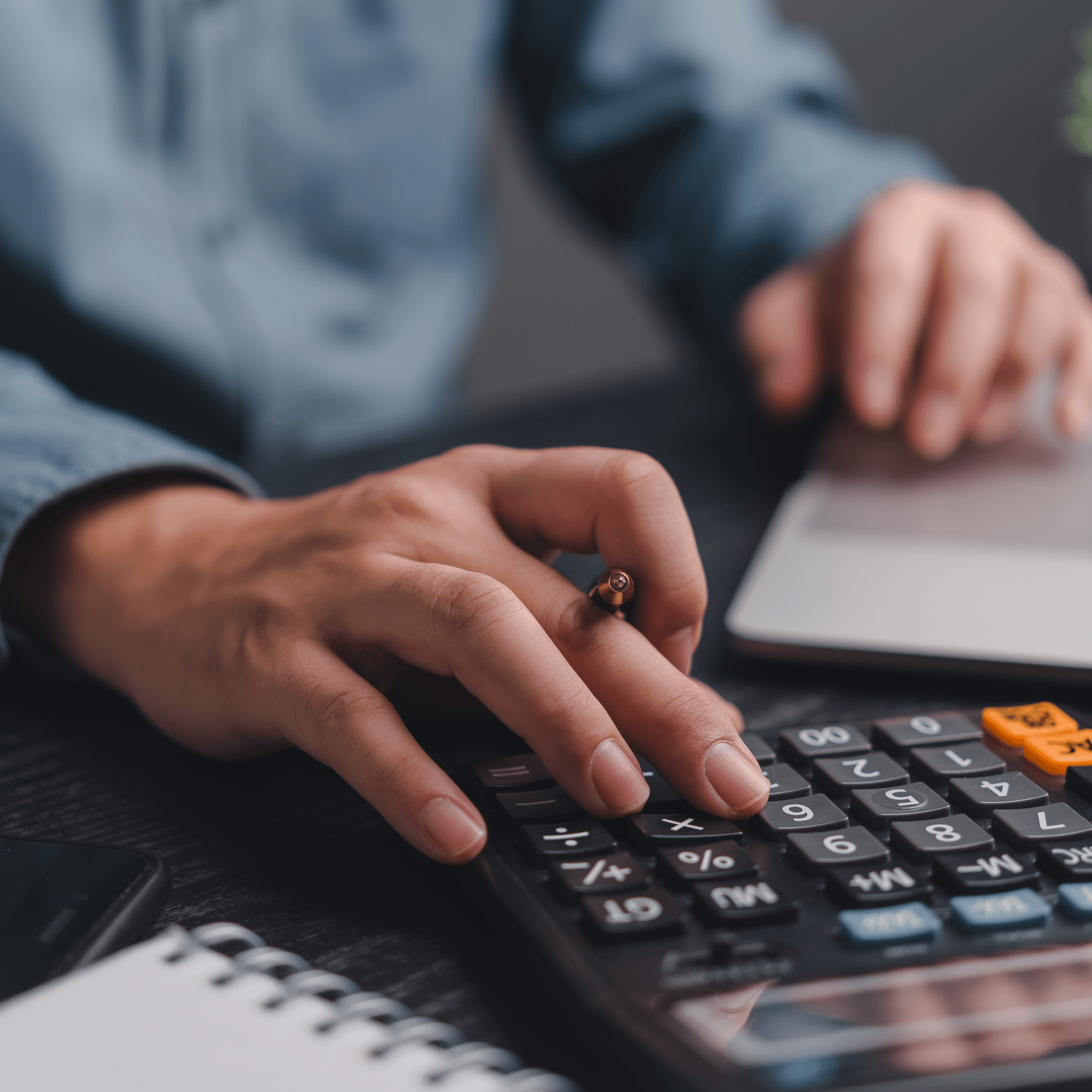 Professional bookkeeper working with calculator and laptop