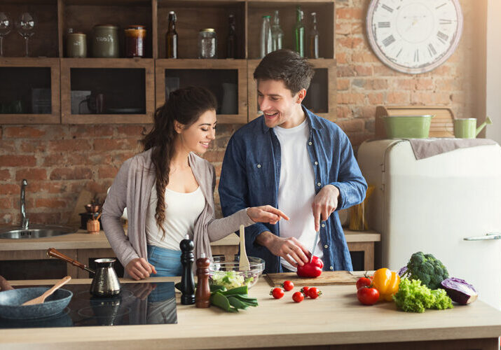 Young couple in kitchen prepping healthy meal — lifestyle at Southwest Acupuncture