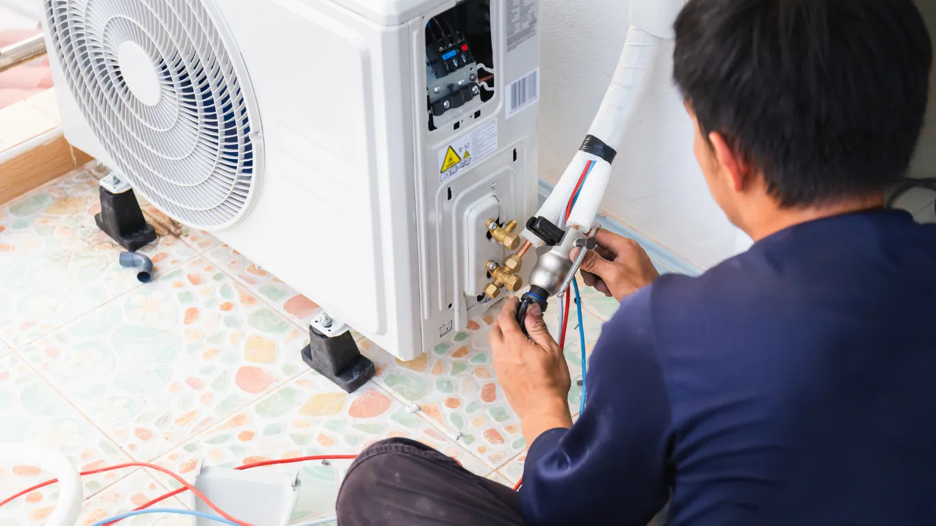 HVAC technician repairing indoor unit