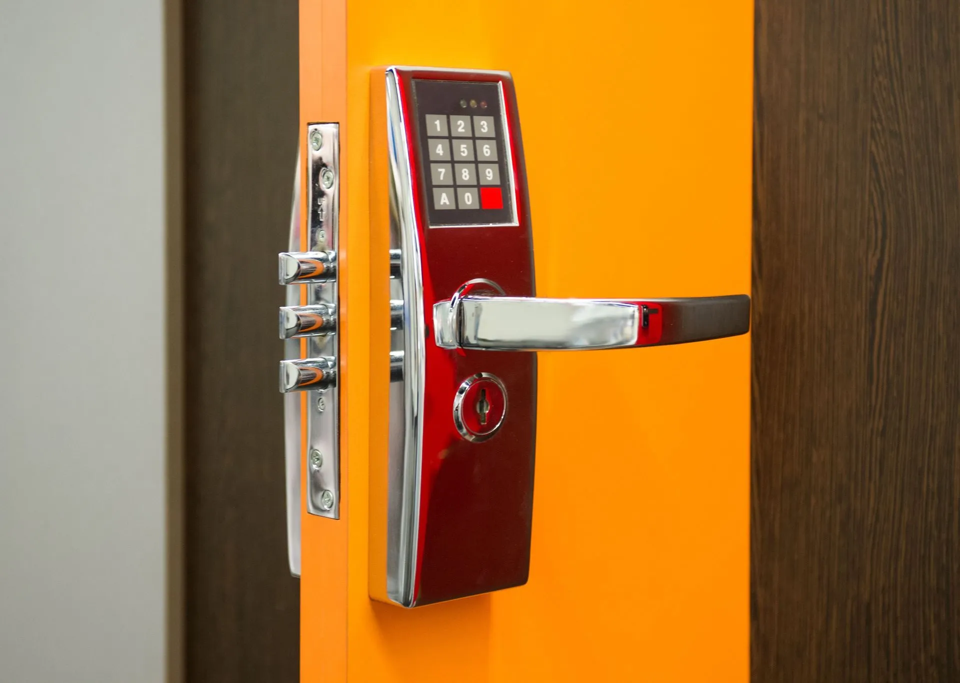 Red and silver smart door lock with keypad