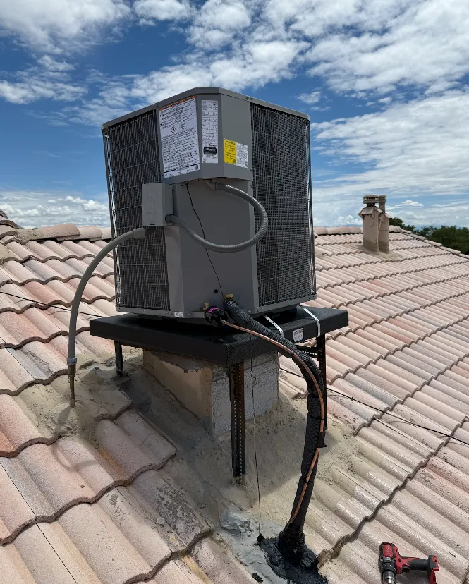A person fixing an air conditioner with a drill